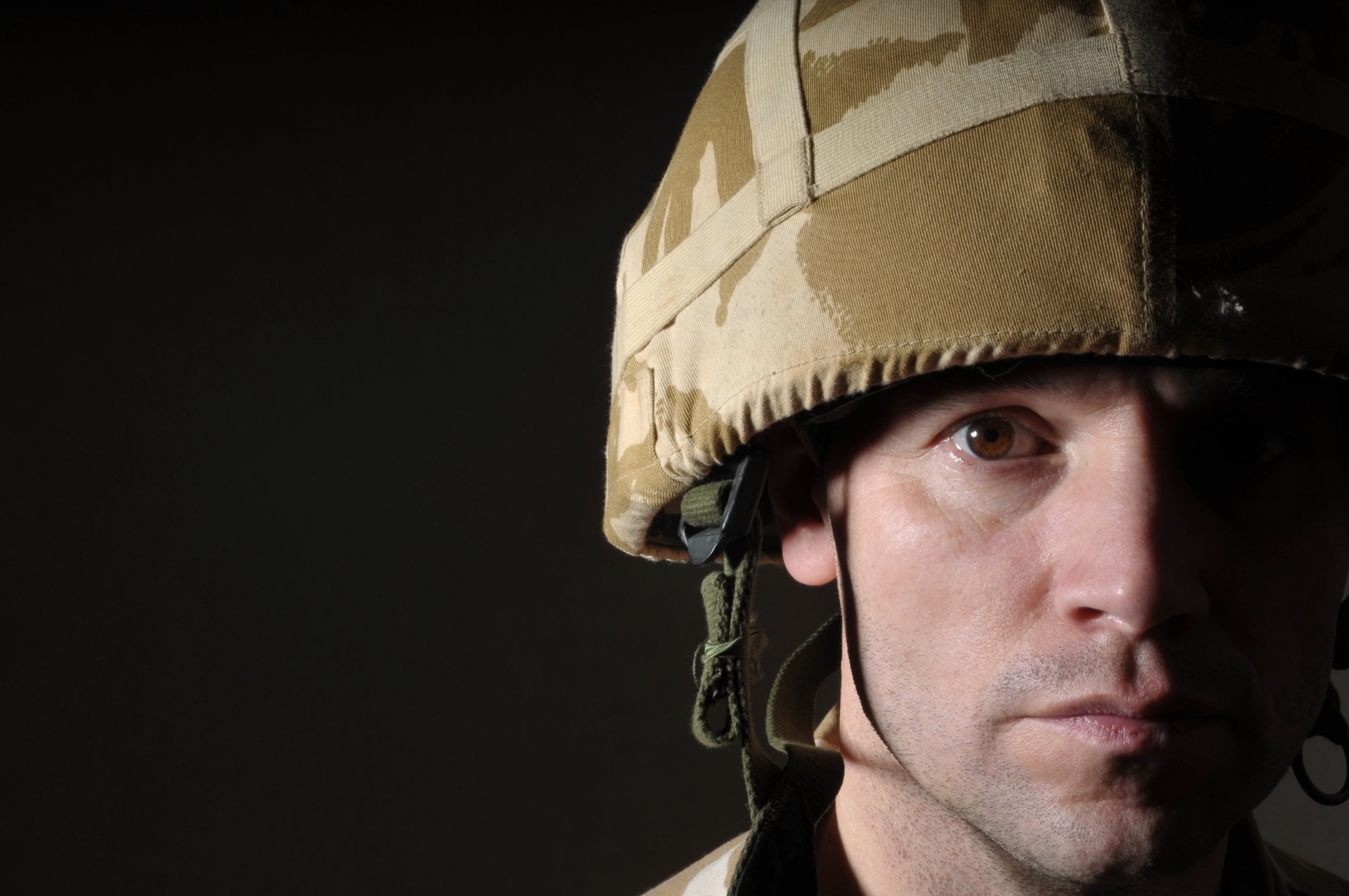 PTSD Soldier With Half Face In Shadow. Photo by John Gomez on Shutterstock
